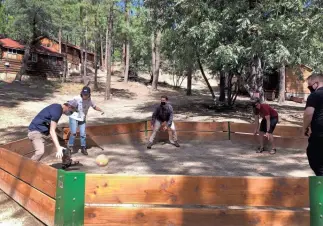  ?? RACHEL LEINGANG/THE REPUBLIC
Arizona Republic
| USA TODAY NETWORK ?? A Place Beyond and CampWay staff play “gaga ball” at Friendly Pines camp, which will soon house dozens of college students from around the country.