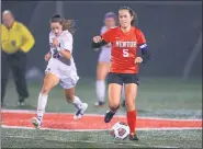  ?? TIM PHILLIS — FOR THE NEWS-HERALD ?? Mentor’s Emma Lerner plays a touch Oct. 26 as Solon’s Lauren Tomasetti closes in during a Division I district semifinal at Mentor. The Cardinals won, 2-0.