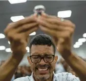  ?? RODRIGO ABD/AP ?? A man raises a cup of wine at a rally for evangelica­l electoral candidates on Sept. 17 in Salvador, Brazil.