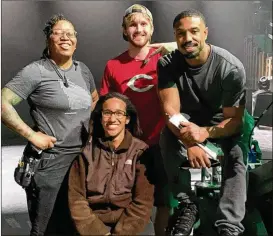  ?? COURTESY OF GABRIELLE DUNNINGS ?? Gabrielle Dunnings (seated) on the set of “Creed III” with the movie’s star, Michael B. Jordan (right), and other members of the crew.