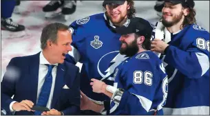  ?? DIRK SHADD/TAMPA BAY TIMES ?? Tampa Bay Lightning head coach Jon Cooper celebrates with Andrei Vasilevski­y (88), Nikita Kucherov (86) and Mikhail Sergachev (98) after taking a selfie with them during the Stanley Cup party on the ice on Wednesday, in Tampa, Fla.