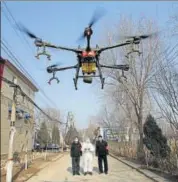  ??  ?? A drone sprays disinfecta­nts in Zhengwan, China.
REUTERS