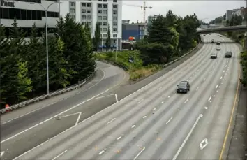  ?? Bettina Hansen/Seattle Times via AP ?? Two women were struck and critically injured early Saturday when a car sped through their small protest gathered on a closed Interstate 5 near the Yale Avenue on-ramp in Seattle.