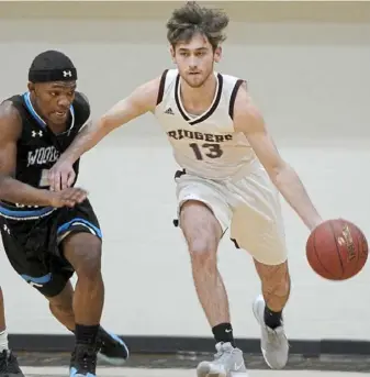  ?? Pam Panchak/Post-Gazette ?? Woodland Hills’ Tre’mon Josey defends Ambridge’s Anthony Cvitkovic on a fast break at the Midland Tournament at Geneva College Friday.