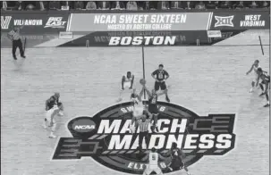  ?? The Associated Press ?? OH SO SWEET 16: Villanova’s Omari Spellman (14) and West Virginia’s Sagaba Konate (50) jump for the opening tip Friday’s East Regional semifinal in Boston.