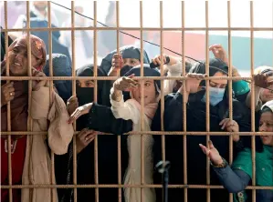  ??  ?? Afghan women wait to apply for a Pakistani visa, after others were killed in a stampede for tokens in Jalalabad on Wednesday. — Reuters