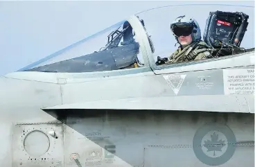  ?? ALBERTO PIZZOLI / AFP / GETTY IMAGES FILES ?? A Canadian CF-18 jet pilot from 3 Wing Bagotville, Que., sits in his plane upon arrival from a mission. The auditor general’s report warned Tuesday that Canada’s fighter jet capabiliti­es are being limited by a lack of trained pilots.