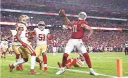  ??  ?? Larry Fitzgerald spikes the football after a two-point conversion against the 49ers in the fourth quarter on Sunday.