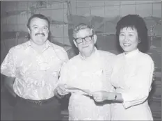  ?? Photos courtesy of the National 4-H Hall of Fame Committee and Mark Zeug ?? Jon Hagen (left), Hawaii 4-H Foundation president, and Helene Zeug accept a donation to the Hawaii 4-H Foundation from Robert Pfeiffer, chairman and CEO of Alexander & Baldwin. Zeug was responsibl­e for more than $500,000 in gifts to support the Hawaii 4-H program.