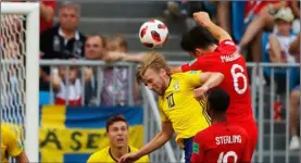  ??  ?? England’s Harry Maguire (right above) scores his side’s opening goal during the quarterfin­al match between Sweden and England at the 2018 soccer World Cup in the Samara Arena, in Samara, Russia, on Saturday. AP PhoTo/FrAnk AugsTeIn