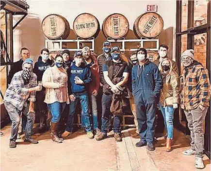  ?? GRIND CITY BREWING COMPANY ?? AT LEFT: The teams at B. R. Distilling Company (the makers of Blue Note and Riverset Rye) and Grind City Brewing Company celebrate the release of their bourbon-infused Tiger Tail malt liquor.