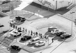  ?? MIKE STOCKER/AP ?? Police evacuate students from Marjory Stoneman Douglas High School in Parkland in 2018.