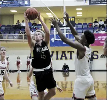  ?? Photoi by Tony Anrold ?? Zane Paul of Botkins puts up aa shot during Friday’s regional final against Cedarville at Butler. The Trojans won to advance to the Division IV state semifinals next Friday at Dayton.