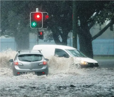  ?? Pictures / News Ltd ?? roads across Sydney, with at least 13 people having to be rescued after being trapped in their cars.
