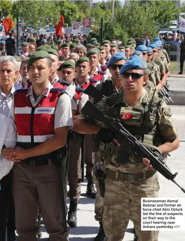  ?? AFP ?? Businessma­n Kemal Batmaz and former air force chief Akin Ozturk led the line of suspects on their way to the court hearing near Ankara yesterday