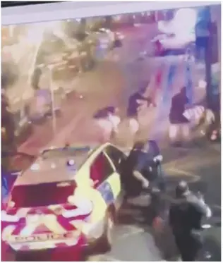  ??  ?? Armed police officers walk past newly installed barriers on London Bridge in London, right. Meanwhile, the Met yesterday released video images from the attack which show the terrorists being shot by officers