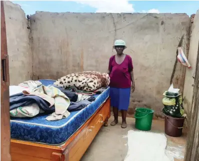  ?? ?? A woman stands in a roofless house after heavy rains left a trail of destructio­n in Matekenya village in Gwanda district, Matabelela­nd South province