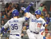  ?? John Bazemore Associated Press ?? CODY BELLINGER, left, greets Max Muncy with a forearm bash after Muncy’s three-run homer.