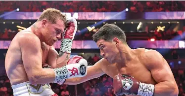  ?? Photo: Matchroom* ?? WBA light heavyweigh­t champion Dmitry Bivol (right) pounds Saul ‘Canelo’ Alvarez’s body during their fight at the T-Mobile Arena in Las Vegas on May 7, 2022.