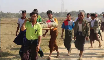  ?? — AFP photo ?? File photo shows residents carrying a body of an ethnic Rakhine woman for burial in Rathedaung township after fresh fighting in Rakhine state between the Myanmar military and the Arakan Army, an ethnic Rakhine force.