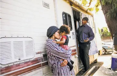  ?? Photos by Gabrielle Lurie / The Chronicle ?? Mataele Robertson lives with son Arnez Clark and boyfriend Arnell Clark in an RV in East Palo Alto.