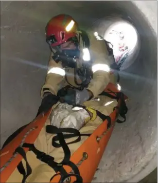  ?? SUBMITTED ?? A member of the Chagrin/Southeast Regional Haz-Mat Response Team prepares to bring a colleague out of a 30-inch, 15-foot-long confined space on a “hauling system” SKED stretcher during a training session on Sept. 25 in Parma at Tri-C’s Public Safety Training Center.