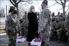  ?? AP PHOTO/JACQUELYN MARTIN, POOL ?? First lady Jill Biden surprises National Guard members outside the Capitol with chocolate chip cookies, Friday, Jan. 22, 2021, in Washington.