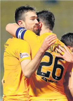  ??  ?? Delight Ryan Hardie celebrates his goal with captain Craig Halkett