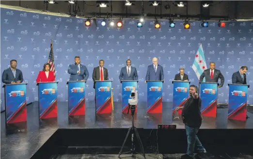  ?? TYLER PASCIAK LARIVIERE/SUN-TIMES ?? Mayoral candidates (from left) Ja’Mal Green; Ald. Sophia King (4th); state Rep. Kam Buckner; businessma­n Willie Wilson; Cook County Commission­er Brandon Johnson; former CPS CEO Paul Vallas; Mayor Lori Lightfoot; Ald. Roderick Sawyer (6th); and Rep. Jesús “Chuy” García prepare for the NBC5 forum Monday.