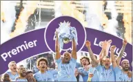  ?? Getty Images ?? Manchester City’s Belgian defender Vincent Kompany holds up the Premier League trophy Sunday in Brighton, England, after became the first side in a decade to retain the Premier League title.