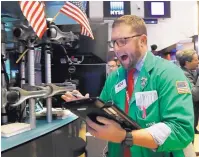  ?? AP PHOTO/RICHARD DREW ?? Trader Ryan Falvey works on the floor of the New York Stock Exchange on Wednesday. The Dow Jones Industrial Average plunged more than 800 points, its worst drop in eight months.