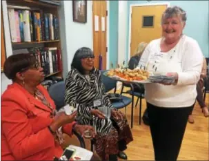  ?? PEG DEGRASSA — DIGITAL FIRST MEDIA ?? Elaine Bazis, a member of Schoolhous­e Center, serves hors d’oeuvres to Trindy Grundy, director of Senior Community Services’ Long Term Care program, left, and Renee Ransom, of Lansdowne, a two-year volunteer with the SCS Aging at Home program.