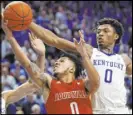  ?? James Crisp The Associated Press ?? Kentucky guard Ashton Hagans blocks a shot by Louisville guard Lamarr Kimble in overtime of the Wildcats’ 78-70 win Saturday at Rupp Arena.