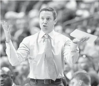  ?? JOE SKIPPER/AP ?? Florida coach Mike White watches his Gators fall 71-69 to South Carolina on Saturday in the SEC opener in Gainesvill­e.