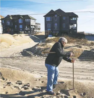  ?? Photos by Jahi Chikwendiu/the Washington Post ?? LEFT: Gus Gusler sets markers for his house to be moved.