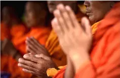  ?? — AFP photo ?? Monks attend a Buddhist prayer for the missing children near Tham Luang cave.