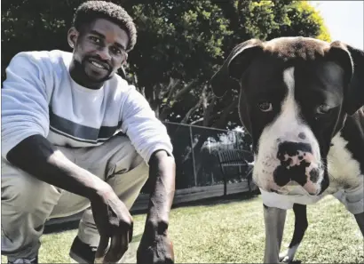  ?? AP PHOTO/ RICHARD VOGEL ?? Ro Mantooth plays with his dog, Champ, at a dog park with the nonprofit People Assisting the Homeless, in the Venice section of Los Angeles on April 5.