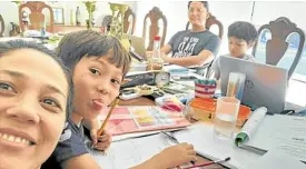  ??  ?? It’s school work at the dining table, with (from left) mom Akiko, Elijah, dad Chips and Noah.