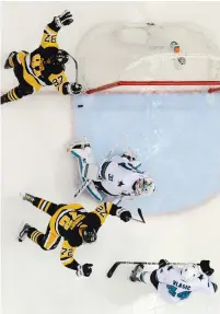  ?? (Reuters) ?? PITTSBURGH PENGUINS center Sidney Crosby (87) and right wing Patric Hornqvist celebrate after the game-winning goal by left wing Conor Sheary (not pictured) past San Jose Sharks goalie Martin Jones in the overtime period of Game 2 of the Stanley Cup...