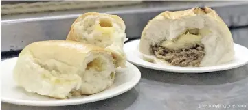  ??  ?? Silimian cafeteria must-try- cheesebrea­d and baked siopao