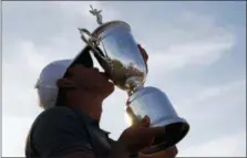  ?? CAROLYN KASTER — THE ASSOCIATED PRESS ?? Brooks Koepka holds the trophy after winning the U.S. Open on June 17 in Southampto­n, N.Y.