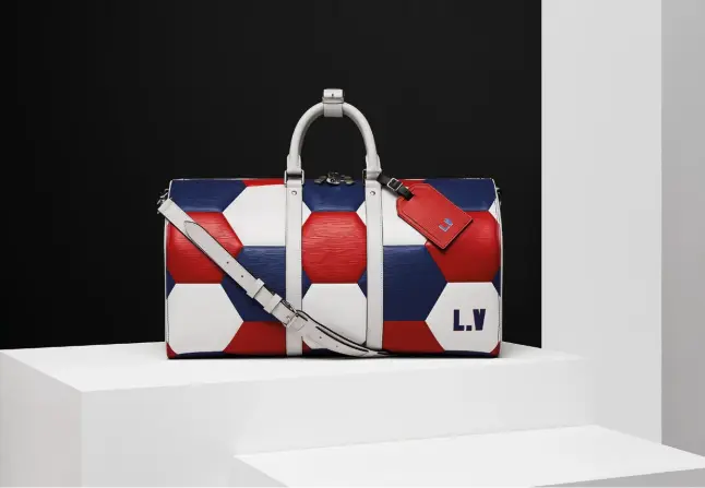  ??  ?? FOOTBALL FEVER The playful look of Louis Vuitton’s 2018 Fifa World Cup Russia Licensed Product Collection is created through a highly technical embossing process on the maison’s classic Epi leather. Opposite page: The titanium-covered Fifa World Cup Trophy Travel Case