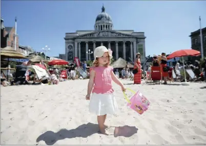  ?? PICTURES: REUTERS ?? SWELTERING: Two-year-old Amelia Scott plays on an urban beach during hot weather in Nottingham, central England. Britain’s first prolonged heatwave in seven years has taken the country by surprise, with rails buckling, shops selling out of electric...