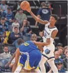  ?? JUSTIN FORD / USA TODAY SPORTS ?? Grizzlies guard Ja Morant (12) looks to pass against Warriors guard Alec Burks (8).