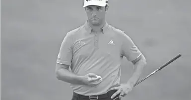  ?? AARON DOSTER/ USA TODAY SPORTS ?? Jon Rahm waits to putt on the 18th green during the final round of the Memorial on July 19 at Muirfield Village Golf Club that clinched his win and rise to No. 1.