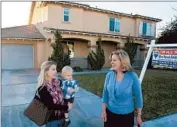  ?? Allen J. Schaben Los Angeles Times ?? IN THE YUCAIPA area, Shannon Bridgewate­r, with son Brayden, confers with agent Carey Chenoski.