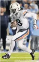  ?? GRANT HALVERSON/GETTY ?? Virginia’s Bryce Perkins put up a school-record 490 yards of total offense in the win over North Carolina.