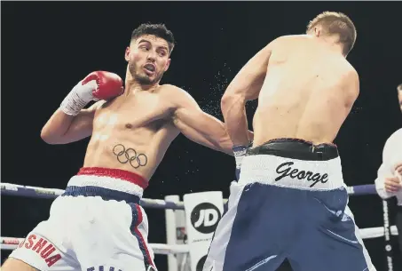  ??  ?? Josh Kelly in action against Kris George in their Commonweal­th/WBA Continenta­l Welterweig­ht title fight at the Metro Arena. Picture by Lawrence Lustig.