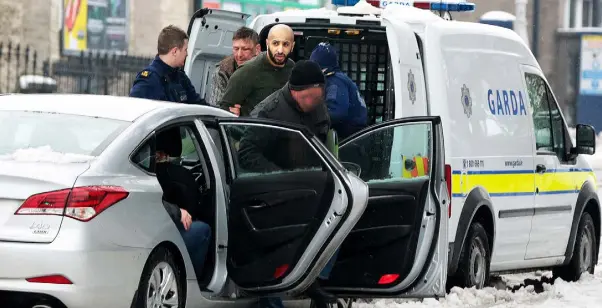  ??  ?? CHARGES: John Kelly, second from left, and Mohammad Smeu, centre, ariving at the Criminal Courts of Justice. Photo: David Conachy