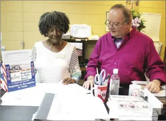  ?? Brodie Johnson • Times-Herald ?? Deputy St. Francis County Clerks Rose Cochran, left, and Derrick Parker review a couple of voter registrati­on forms that were recently turned in at the office in the courthouse. Today is National Voter Registrati­on Day. The deadline to register to vote in the Nov. 8 general election is Tuesday, Oct. 11. Early voting in the election begins on Monday, Oct. 24.